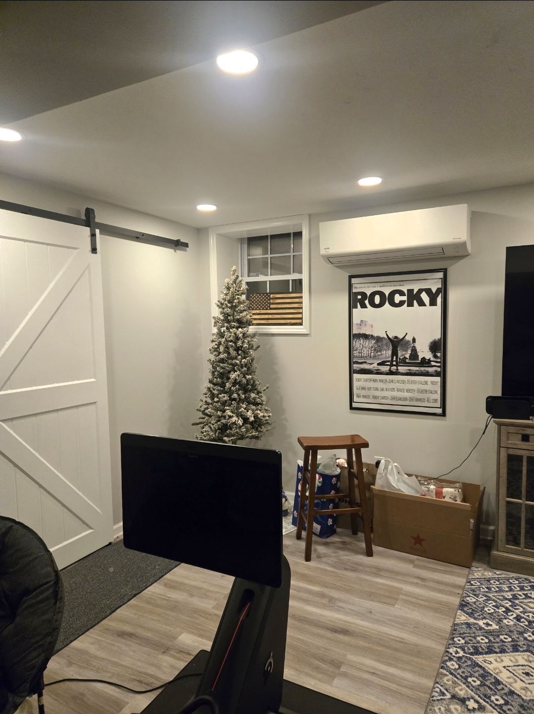 Wall-mounted ductless mini split installed high on the wall of a finished room